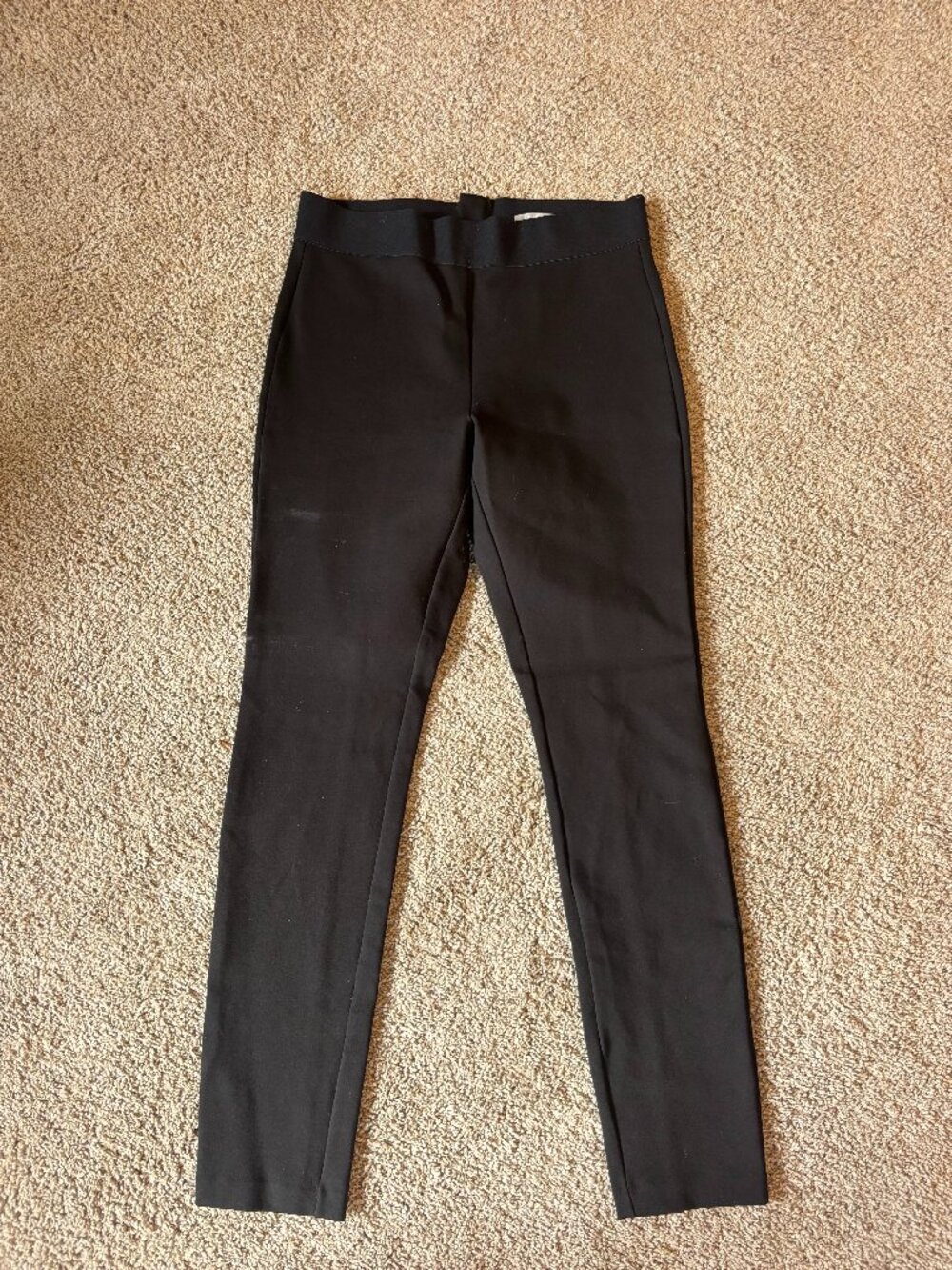 Black high-waisted trousers with zipper detail